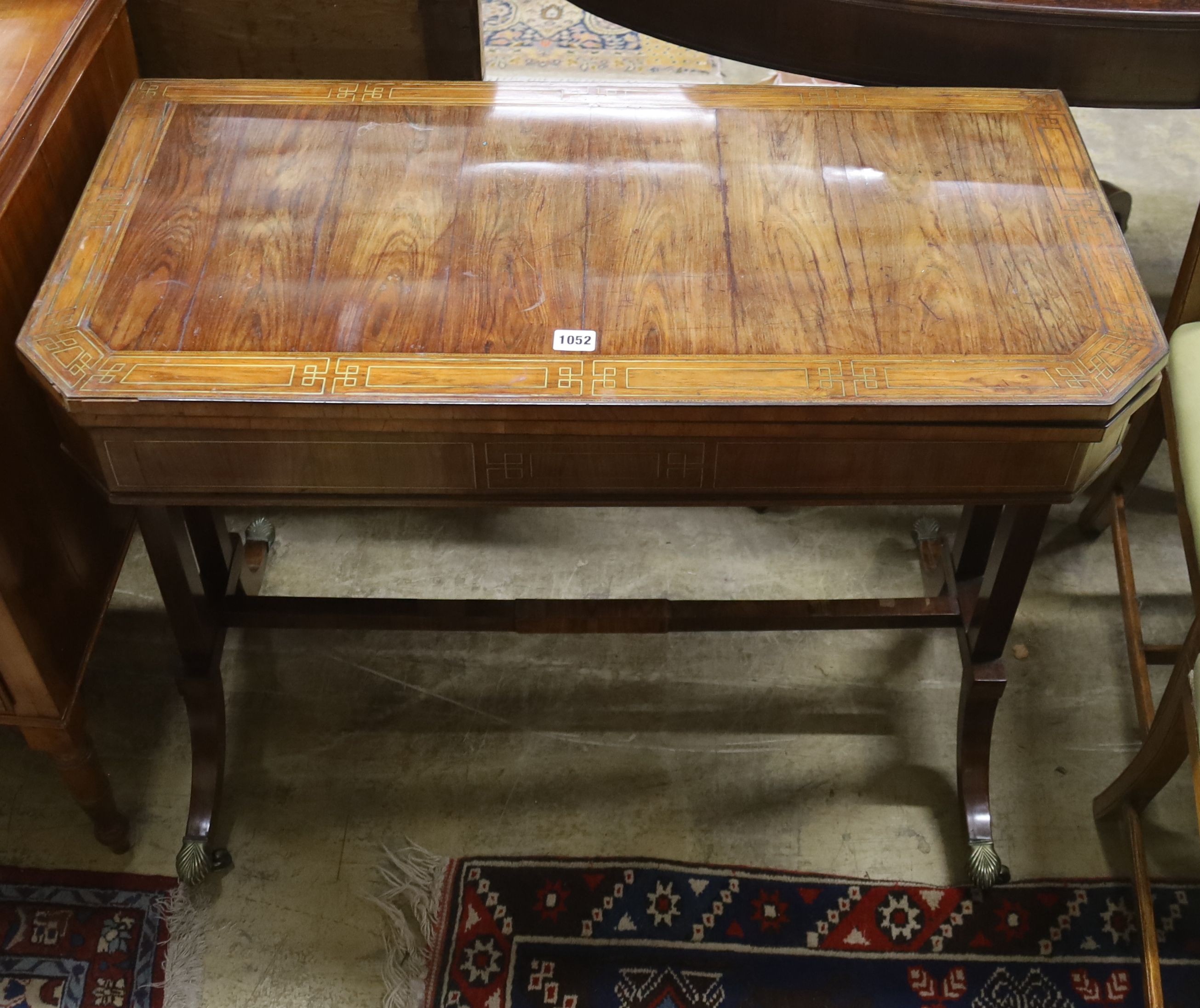 A Regency Kingwood folding card table, banded and brass line inlaid, width 89cm, depth 44cm, height 71cm